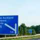 Image of a blue UK motorway road sign directing towards Bishop Auckland