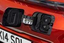 Kia Soul EV (2023): charging port close-up, orange paint