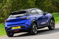 Vauxhall Mokka Electric review, driving, blue, rear three quarters | Parkers