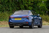 Audi A6 saloon (2025) review: rear three quarter cornering, blue paint, low angle