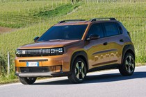 Fiat Grande Panda Hybrid (2025) review: front three quarter driving, bronze paint
