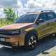 Fiat Grande Panda Hybrid (2025) review: front three quarter driving, gravel road, bronze paint