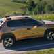 Fiat Grande Panda Hybrid (2025) review: side view driving, bronze paint, high angle