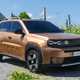Fiat Grande Panda Hybrid (2025) review: front three quarter driving, low angle, bronze paint