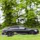 Image of a black Audi S8 driving around a corner, looking at its right side