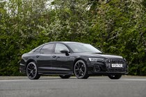 Image of a static, black Audi S8, looking at its front right corner