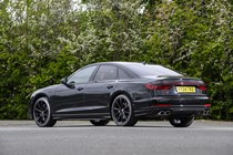 Image of a static, black Audi S8, looking at its rear left corner