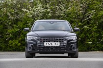 Image of a static, black Audi S8, looking at its front end