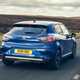 Renault Clio (2023) review: rear three quarter driving, country lane, blue paint