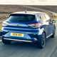 Renault Clio (2023) review: rear three quarter driving, close up, country lane, blue paint
