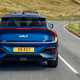 Kia EV6 GT review - facelift, rear, blue, driving round corner