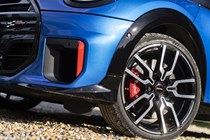 Close-up view a blue MINI JCW showing the front left wheel