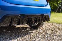 Close-up view of a blue MINI JCW's rear diffuser and exhaust outlet
