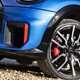 Close-up view a blue MINI JCW showing the front left wheel