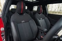 Image of a MINI JCW's front seats, viewed from the front towards the back of the car