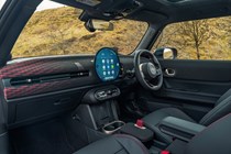 Image of the MINI JCW's front interior, looking across from the open passenger door