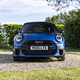 Image of a blue MINI JCW, viewed from head-on