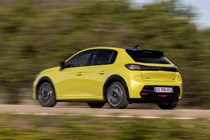 Peugeot E-208 review - facelift, rear view, driving, yellow
