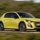 Peugeot E-208 review - facelift, front view, driving, yellow