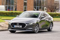 Mazda 3 Saloon review, front, grey, driving round corner