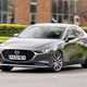Mazda 3 Saloon review, front, grey, driving round corner