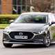 Mazda 3 Saloon review, front, grey, driving round roundabout