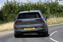 Volkswagen Golf (2024) review: rear three quarter driving, grey paint