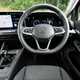 Volkswagen Golf (2024) review: dashboard and infotainment system, from the driver's seat, black and grey fabric upholstery