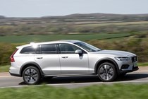 Volvo V60 Cross Country (2023) review: side view driving, taken from driver's-side of car, silver paint, rural background