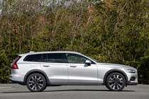 Volvo V60 Cross Country (2023) review: side view static, silver paint, wooded background
