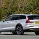Volvo V60 Cross Country (2023) review: rear three quarter static, silver paint, wooded background
