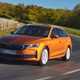 Skoda Octavia Estate review, Mk4 facelift, orange, front, driving round corner