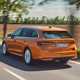 Skoda Octavia Estate review, Mk4 facelift, orange, rear, driving past trees