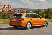 Skoda Octavia Estate review, Mk4 facelift, orange, rear, Czech castle in the background