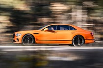 Bentley Flying Spur review - V8 plug-in hybrid, Mandarin orange, side, driving