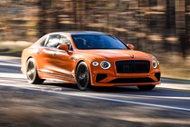 Bentley Flying Spur review - V8 plug-in hybrid, Mandarin orange, front, driving round corner