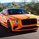 Bentley Flying Spur review - V8 plug-in hybrid, Mandarin orange, front, driving