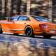 Bentley Flying Spur review - V8 plug-in hybrid, Mandarin orange, rear, driving