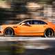 Bentley Flying Spur review - V8 plug-in hybrid, Mandarin orange, side, driving