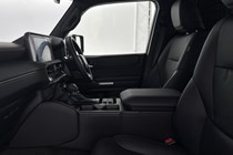 Image of the Toyota Land Cruiser Commercial's front seats and dashboard, viewed through the open front passenger door