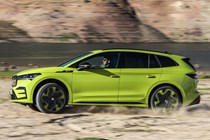 Skoda Enyaq iV vRS (2022) review: side off-road action shot, green car, sandy backdrop
