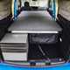 Image of the Volkswagen Caddy California interior with the bed folded out