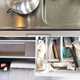 Image of an open campervan cutlery drawer stuffed with hankies to prevent rattles