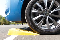 Image of levelling wedges under the front wheel of a Volkswagen California