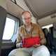Man looking through a first aid kit in a campervan