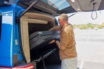 Image of a man removing the mattress from a campervan