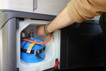 Close-up image of a campervan gas bottle being disconnected