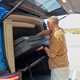 Image of a man removing the mattress from a campervan
