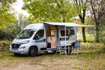 Image of a Vantage Motorhomes Sol Fiat Ducato with awning and furniture set up