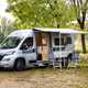 Image of a Vantage Motorhomes Sol Fiat Ducato with awning and furniture set up